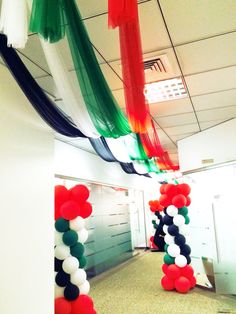 an office hallway decorated with balloons and streamers