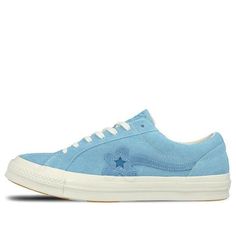 The Converse X Golf Le Fleur One Star is a sneaker that combines premium style with unbeatable comfort. The Bachelor Blue suede upper is accented with white contrast stitching and a floral One Star logo, while the cream vulcanized midsole ensures a cushioned ride. The orange rubber outsole provides grippy traction and completes the look. Whether you're hitting the streets or the golf course, this shoe has you covered in style. White Low-top Sneakers With Contrast Stitching, Lace-up Sneakers With Contrast Stitching For Streetwear, Low-top Sneakers With Contrast Stitching For Streetwear, Casual Low-top Sneakers With Contrast Stitching, Blue High-top Sneakers With Stitched Sole, White Sneakers With Contrast Stitching For Sports, Sporty Converse Skate Shoes With Contrast Sole, Low-top Leather Sneakers With Contrast Stitching, Sporty Streetwear Sneakers With Stitched Sole