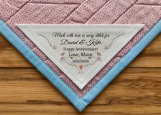 a pink and blue quilted triangle with the words made with love for linda on it