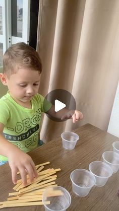 a little boy that is playing with some toothpicks