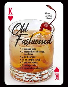 an old fashioned cocktail with orange slices and cherries on the rim, sitting in front of playing cards