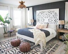 a bedroom with black walls and white furniture