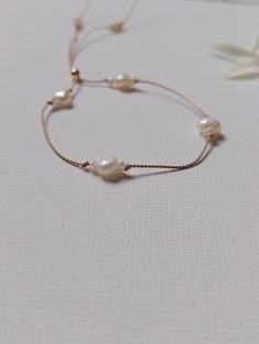 Minimalist Style Dainty Pearl Silk bracelet Tiny quality Grade AAA ivory freshwater pearls and larger pearls, very luxurious entwined on natural beige silk for a strong but delicate look Silk Cord Adjustable size small bracelet. If you require a larger size get in touch for a price. 14k rose gold filled toggle bead Handmade in my home studio If you wish to have guaranteed next day delivery - choose the delivery upgrade listing https://www.etsy.com/uk/listing/1013365129/delivery-upgrade-uk-only?r Silk Bracelet, Beige Silk, Small Bracelets, Dainty Bracelet, Etsy Bridesmaid Gifts, Silk Cord, Minimalist Bracelet, Dainty Bracelets, Home Studio