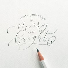 a pencil is laying on top of a piece of paper with the words be merry and bright written in cursive writing