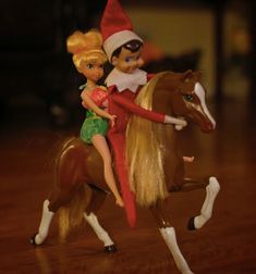 a elf riding on the back of a brown horse next to a blonde haired girl