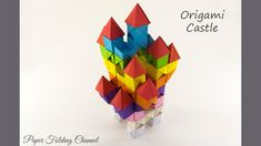 an origami castle made out of colored paper on a white background with text