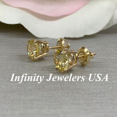 "These earrings are round cut yellow simulated diamonds made with solid 14k yellow gold item #6500 -Approximate total carat weight: 2.50 -Center Stone Size: 7mm approx. 1.25ct each diamond equivalent -Gem Type: simulated diamond -Stone Shape: round -Stone Clarity: VVS1 -Stone Color: yellow -Metal Type and Purity: 14k yellow gold -Setting: 4 prong basket style -Backing: screw back (earring backs are subject to change due to availability) -Country of Manufacturing: USA (Michigan) For customization Yellow Stud Earrings, Luxury Yellow Diamond Round Earrings, Classic Yellow Sapphire Round Cut Jewelry, Yellow Sapphire Earrings Studs, Yellow Round Cubic Zirconia Earrings, Round Solitaire, Solitaire Studs, Yellow Gold Setting, Screw Back Earrings