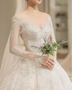 a woman in a wedding dress holding a bouquet