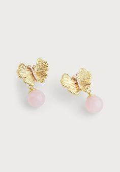 Featuring 18k gold dipped brass, polished light pink quartz, and hand set pavé crystals, these artfully sculpted pieces elevate any occasion. The earrings feature sculpted, bejeweled butterflies with tiny feminine quartz drops, adding timeless glamour to your jewelry wardrobe and making them the perfect accessory, no matter the occasion. Rose Quartz Crystals 18k gold plated brass 0.7" L X 0.5" W Elegant Pink Butterfly Charm Earrings, Elegant Pink Earrings With Butterfly Charm, Real Butterflies, Ginkgo Leaves, Jewelry Wardrobe, Delicate Beauty, Butterfly Jewelry, Gold Dipped, Rose Quartz Crystal