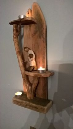 a wooden shelf with candles and a teddy bear on it