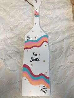 a white cutting board with the words tru delta on it and stars in the background