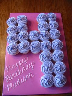 a birthday cake that is shaped like the letter k with frosting on it and icing in the shape of spirals