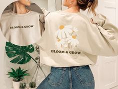 Elevate your wardrobe with our "Bloom and Grow Sweatshirt", a must-have for those who adore bohemian style and trendy pieces. This floral t-shirt features a beautiful flower design, making it the perfect choice for any nature lover. Made for comfort and style, this women's graphic sweater is not only chic but also versatile, ideal for pairing with your favorite jeans or leggings. Embrace the latest fashion trend with this love tee that exudes a sense of growth and positivity. Whether you're searching for a cute teen clothes or a unique gift for her, this botanical sweatshirt with its floral print and oversized fit is the ideal choice. Add a touch of aesthetics to your outfit with this fashionable and timeless piece that is currently trending right now. 🔮 Crafting and shipping from within Spring Cotton Sweatshirt With Custom Print, Spring Long Sleeve T-shirt With Custom Print, Long Sleeve T-shirt With Custom Print For Spring, Custom Print Long Sleeve T-shirt For Spring, Beautiful Flower Designs, Style Sweatshirt, Graphic Sweaters, Gildan Sweatshirts, Flower Shirt