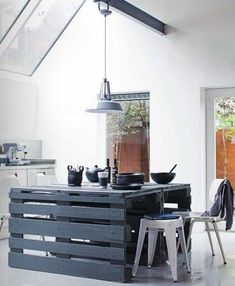 a kitchen with an island made out of wooden pallets