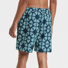 This 4-Way Stretch Elevated Elastic Waist Trunk Swimsuit from Goodfellow & Co™ feature a blue botanical-inspired motif pattern for an attractive look. Made from 4-way stretch, quick-drying fabric, these regular-fit swim trunks are designed with a built-in boxer for comfort in or out of water. A front drawstring on the elastic waist offers you a secure fit, while the UPF 50+ rated material helps keep you protected from the sun. Plus, the side and back pockets provide space to keep small essential Vacation Shorts With Elastic Waistband, Blue Swim Trunks With Elastic Waistband For Vacation, Bermuda Bottoms For Beach Season With Relaxed Fit, Bermuda Bottoms With Built-in Shorts For Poolside, Relaxed Fit Bermuda Bottoms For Beach Season, Comfortable Short Bottoms For Vacation, Comfortable Shorts For Vacation, Comfortable Vacation Shorts, Casual Swim Trunks With Short Leg For Vacation