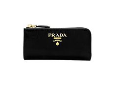 This compact Prada keychain wallet is constructed with black vitello move leather. The zipper fastening opens to a smooth black leather interior with a detachable keychain. The key holder case wallet can fit keys, credit cards, bills, and coins. This functional and stylish piece from Prada is the perfect size to hold your daily essentials!    Model: 1PP026    Black vitello move leather  Gold-tone hardware  Zipper fastening  Prada logo plaque    Detachable keychain, approx. 1.25 inches  Smooth bl Luxury Black Coin Purse With Interior Key Chain Holder, Black Travel Coin Purse With Key Clip, Black Coin Purse With Key Clip For Travel, Black Wallets With Key Clip For Daily Use, Black Rectangular Coin Purse With Key Clip, Classic Formal Coin Purse With Interior Key Chain Holder, Modern Black Wallet With Key Clip, Prada Keychain, Key Chain Wallet