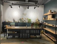 the interior of a store with shelves and vases