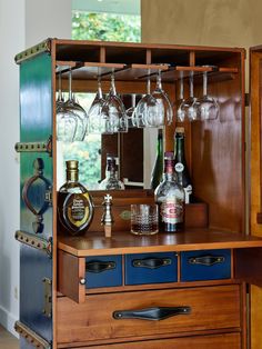 a cabinet with wine glasses and liquor bottles