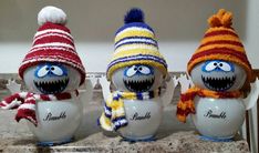 three sesame characters wearing knitted hats and scarves on top of an egg shell