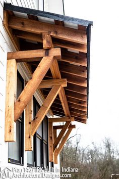 an open window on the side of a building with wooden slats hanging from it's sides