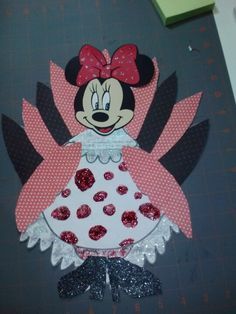 a paper cut out of minnie mouse wearing a pink and white dress with polka dots