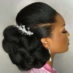 a woman wearing a hair comb with flowers on it's side and pearls in her hair