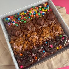 a box filled with lots of different types of cookies and desserts on top of a table