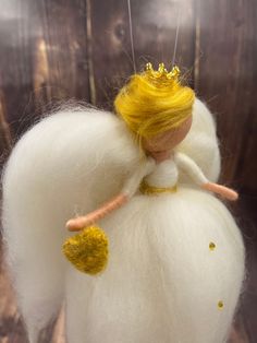 a needle - felt angel ornament made to look like a doll with yellow hair