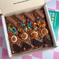 a box filled with lots of different types of cookies and candy on top of a table