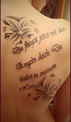 the back of a woman's tattoo with words written on it