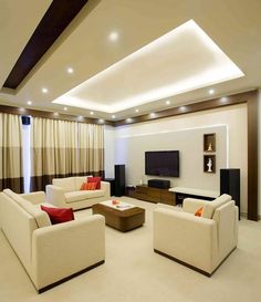 a living room filled with furniture and a flat screen tv mounted on the wall above it