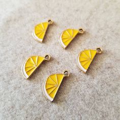 Lovely yellow lemon enamel charms. Yellow and green enamel over soft gold-tone metal alloy. Single sided (gold on back) Measures approximately 8 wide x 17mm tall (including loop) 5 Pieces. Yellow Dragon, Dragon Vein Agate, Lemon Wedge, Jewelry Making Project, Enamel Charms, Yellow And Green, Green Enamel, Beaded Flowers, Make And Sell