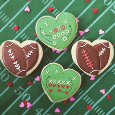 three decorated cookies sitting on top of a green table