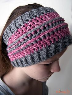 a woman wearing a gray and pink crochet headband on top of her head