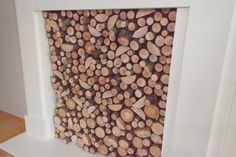 there is a large pile of logs on the floor in front of a white wall