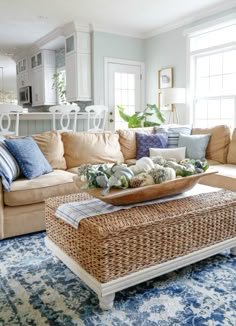 a living room filled with furniture and pillows on top of a blue carpeted floor