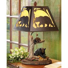 a lamp that is sitting on top of a table next to a bear figurine