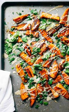 sweet potato salad with parmesan dressing on a baking sheet, ready to be eaten