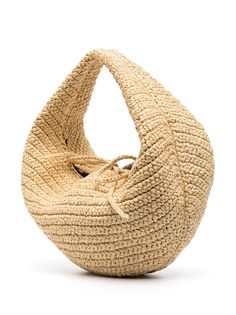 a large woven bag sitting on top of a white surface