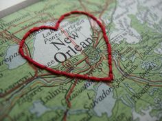 a map with a red heart on it and the word new orleans written in black