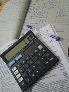 a calculator sitting on top of an open book