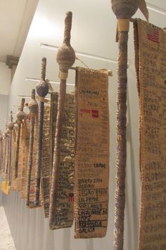 several pieces of fabric hanging from the ceiling in a room with white walls and carpeted flooring