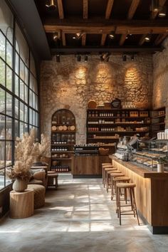 the inside of a restaurant with lots of counter space and stools in front of large windows