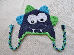 a crocheted hat with eyes and teeth