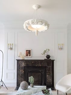 a living room with a fireplace and white walls