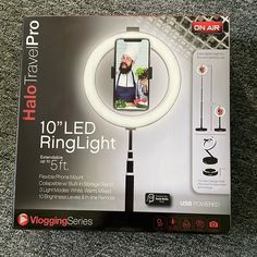 the ring light is in its box on the carpet