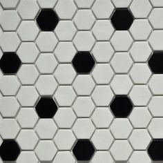 a white tile with black hexagons on it