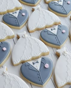 some cookies are decorated with blue and white icing