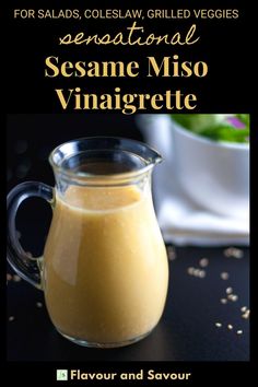 a glass pitcher filled with sesame miso dressing on top of a black countertop