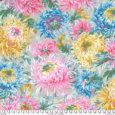 an image of colorful flowers on grey background with ruler in the foreground for scale